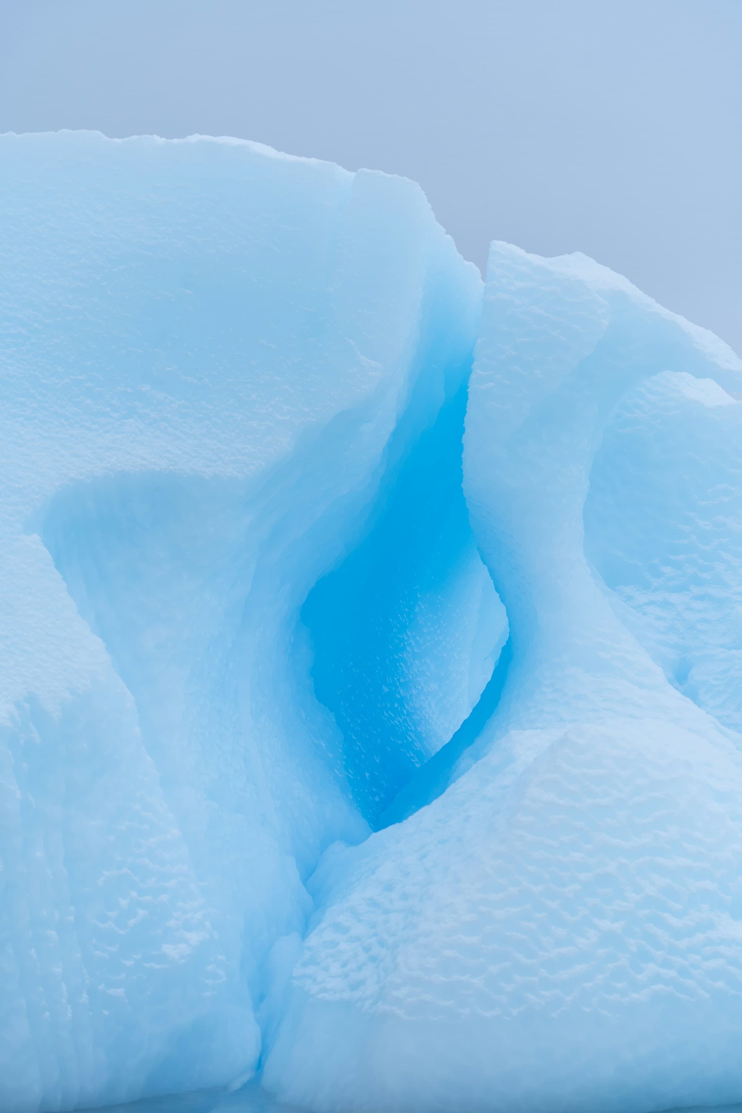An iceberg standing in a dark sea, its full height